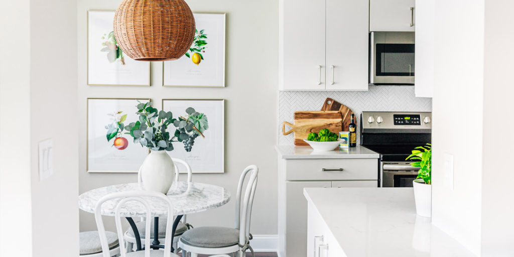 Antique botanical prints, classic marble bistro table, Thonet chairs, wicker rattan pendant, transitional French inspired kitchen