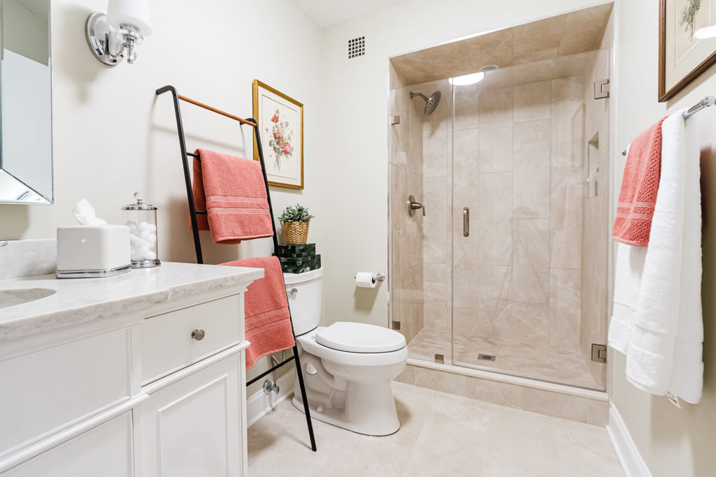 Guest bathroom renovation in white and greige with salmon pink accents inspired by vintage botanical art