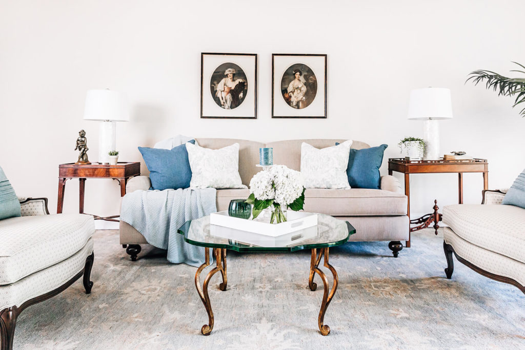 Updated formal living room in taupes and mineral spa blue greens, antique glass table, antique art, antique side table, French inspired design