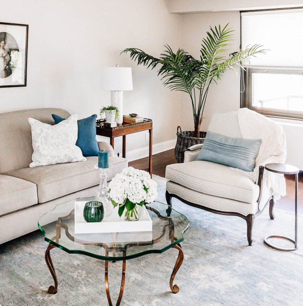 Updated formal living room in taupes and mineral spa blue greens, antique glass table, antique side table, French inspired design