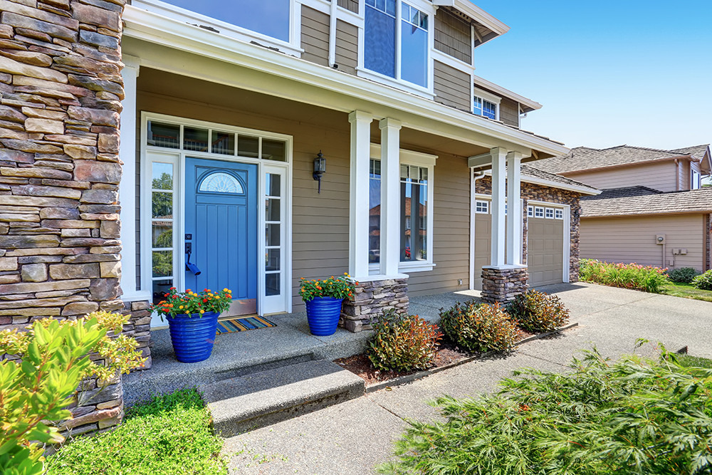 Staged home exterior with fresh paint and flowers